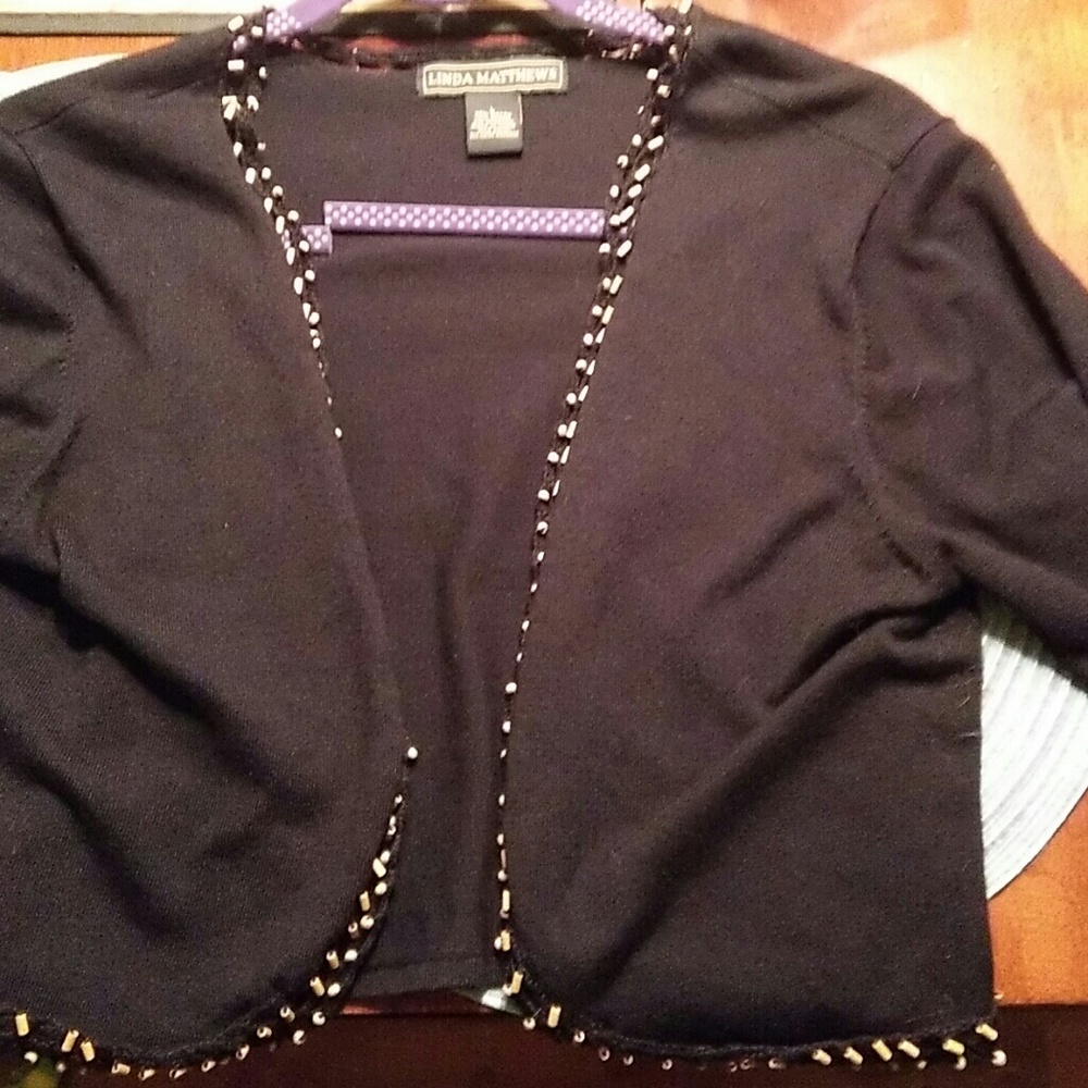 Linda mathews.  Black SHRUG with beads.